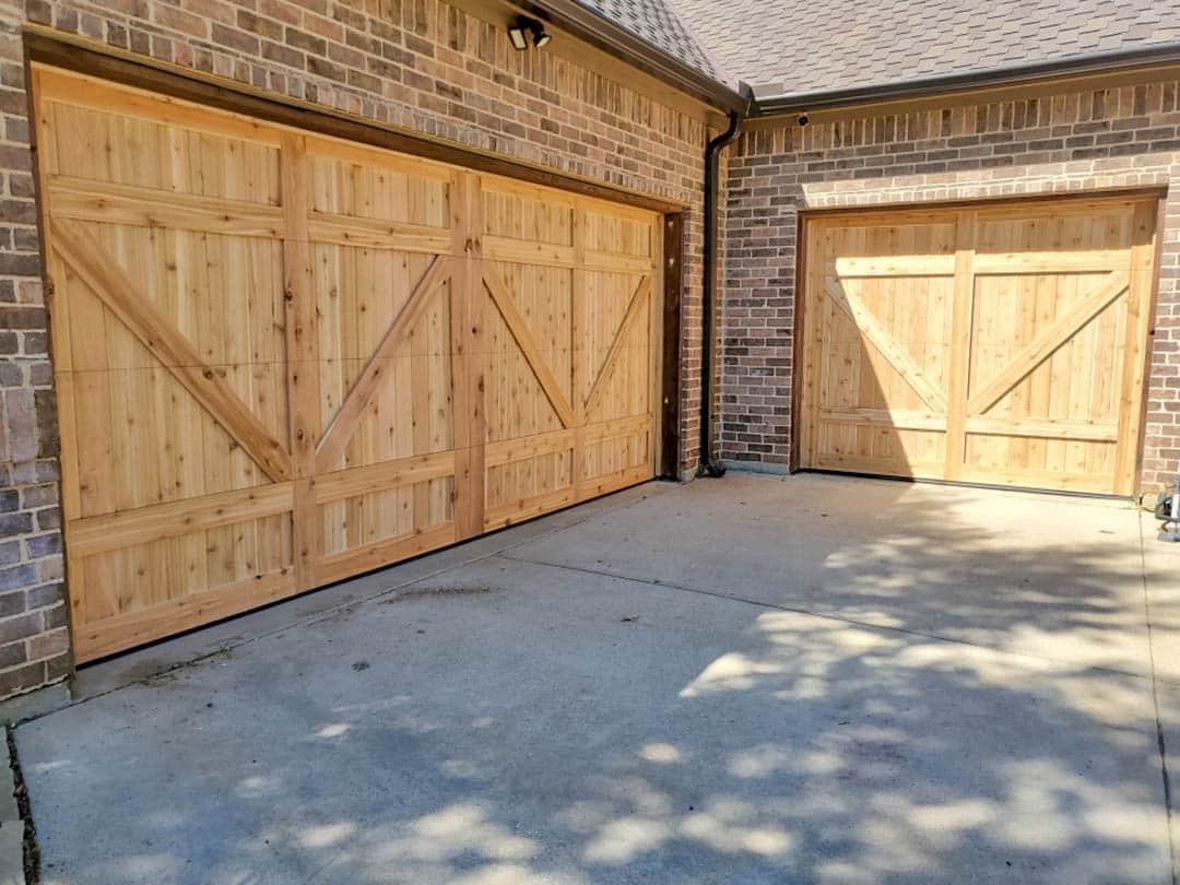 Photo of two garage with new cedar plank doors by Garage Door Rescue, LLC