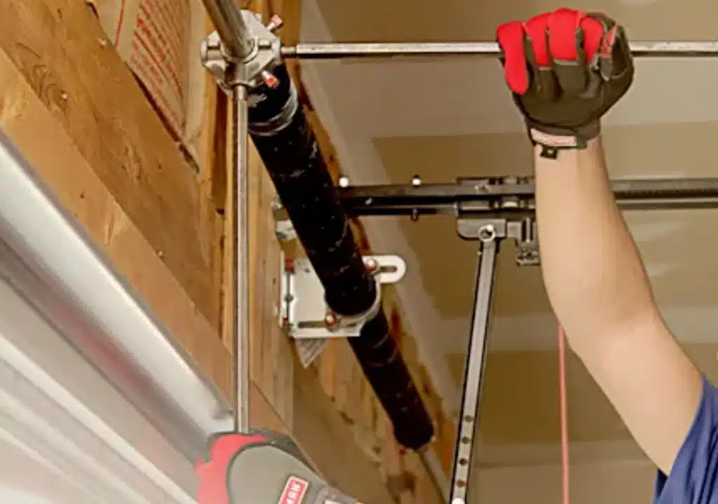 man's hands repairing garage door opener
